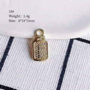 Macro view of gold rectangular jewelry pendant with 12 sparkling crystals and dimensions