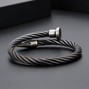 Macro detail of industrial nail screw bracelet with vintage twisted steel cable texture