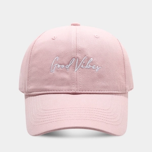 Detailed view of pink cotton baseball cap with Good Vibes embroidery on the front