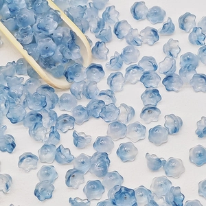 Macro shot of blue gradient lily of the valley glass beads for DIY jewelry making