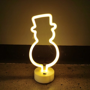 Macro shot of a snowman neon sign with warm yellow LED glow and white base