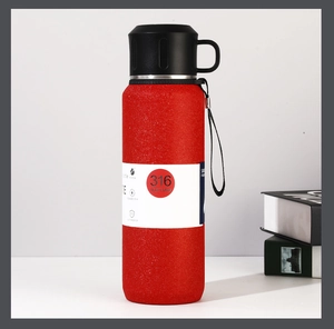 Detail of red matte 316 stainless steel vacuum flask with portable carry strap