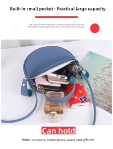 Detail view of the spacious blue round crossbody bag with a detachable inner pouch organizer