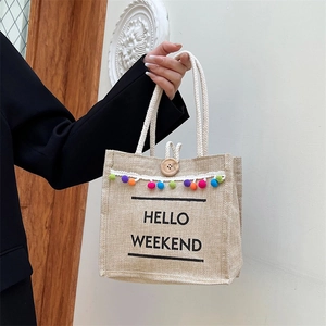 Linen Hello Weekend tote bag with colorful pom-poms and white cotton rope handles