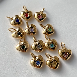 Macro shot of twelve colorful crystal heart pendants in 14K gold plated finish