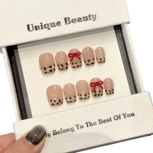 Handmade short square leopard print press-on nails with 3D red bows and nude base
