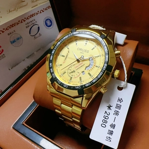 Detail view of the gold chronograph watch face with triple sub-dials and metal bracelet