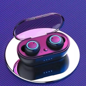 Detail of TWS earphones with blue LED light and translucent purple charging case cover