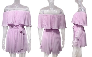 Detail view of pink off-shoulder pleated romper with adjustable belt on white background