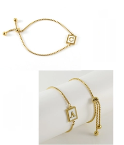 Detail of gold stainless steel shell letter bracelet with adjustable ball slider clasp