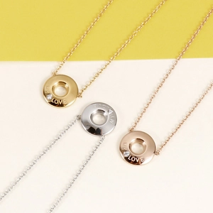 Detailed view of circle pendants in gold silver and rose gold with MY LOVE engraving