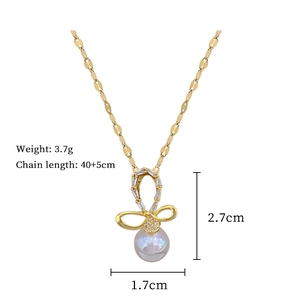 Detail showing bow pendant dimensions of 2.7cm by 1.7cm with pearl and crystal accents
