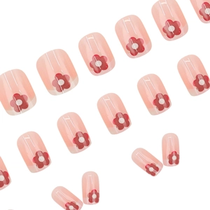 Pink translucent square press-on nails with red floral patterns for a fresh summer look