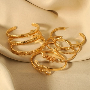 Detail of six-piece 18K gold plated stainless steel knot and twisted cable bangle set