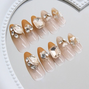 Sparkling heart crystal nails in nude gradient with jelly finish and almond shape