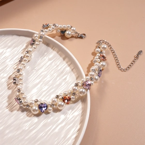 Detailed close-up of double-layer faux pearl necklace with colorful heart-shaped gems