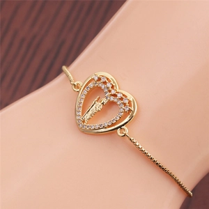 Detail of golden double heart bracelet with zircon and adjustable sliding chain