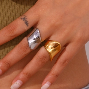 Close-up of gold and silver irregular geometric rings with a polished finish