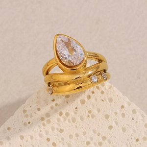 Macro shot of 18K gold-plated triple-layer ring featuring a pear-cut zircon on stone