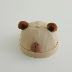 Close-up of beige cotton miki hat featuring cute plush ears and embroidered bear face