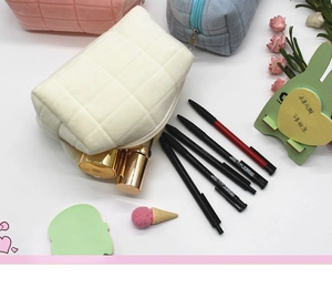 Detailed view of quilted plush storage bags in white, pink, and blue showing large capacity