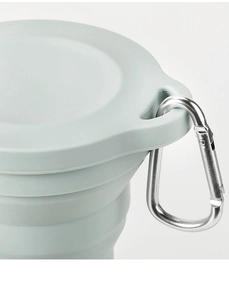 Close-up of portable silicone collapsible cup with a metal carabiner for travel
