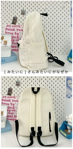Detail view of corduroy backpack showing side pockets and anti-theft back zipper pocket