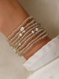 Close-up of bohemian multi-layered waist chain with colorful beads and white pearls