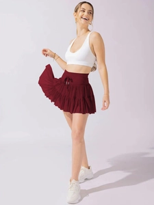 Detail of high waisted pleated burgundy skirt with comfortable built-in safety shorts