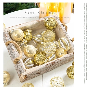 Detailed close-up of gold and white Christmas ornaments in a rustic wooden basket