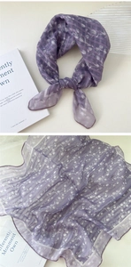 Detailed view of purple floral cotton linen scarf with elegant knot and petal patterns