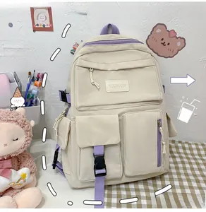 Detail of Korean-style beige canvas backpack with multiple pockets and purple accents