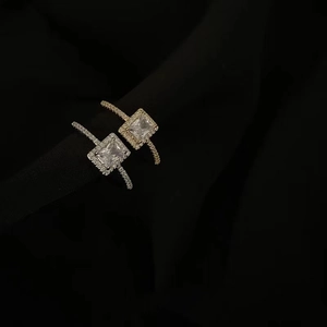 Detailed close-up of square zircon halo rings in silver and gold finish for women