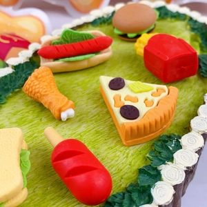 Detailed close-up of cute cartoon fast food erasers featuring hotdog pizza and fries