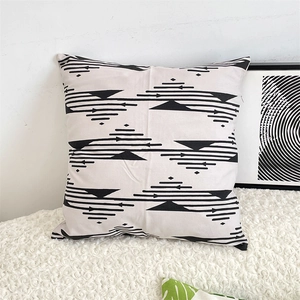 Close-up of beige cotton linen cushion cover featuring black geometric patterns and invisible zipper