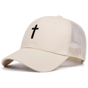 Close-up of black cross embroidery on a beige mesh trucker hat with canvas front
