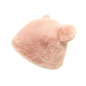 Detailed close-up of fluffy pink faux mink fur winter hat with cute bear ears and thick texture