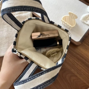 Interior view of striped canvas handbag showing storage capacity for small daily items
