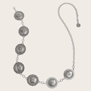 Detail of vintage silver metal chain belt with turquoise concho pendants and ornate engraving