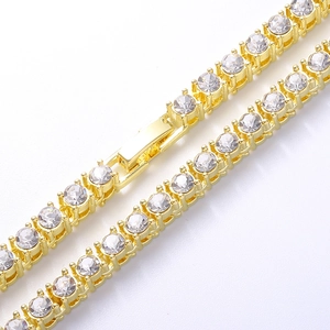 Detail view of 4mm gold tennis chain featuring secure fold-over clasp and CZ claw setting