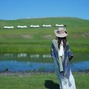 Ethnic knit shawl with tassels in blue and green, shown outdoors by a scenic lake