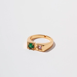 Detail of gold open ring featuring green zircon in square frame and pink star inlay