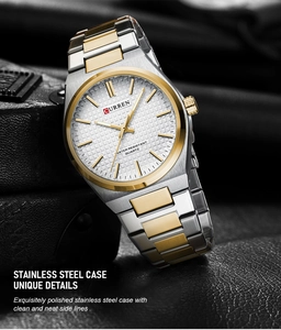 Detailed macro view of the silver and gold stainless steel band on a luxury quartz watch