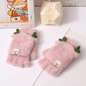 Detail of pink plush fingerless gloves with green antlers and cute deer embroidery