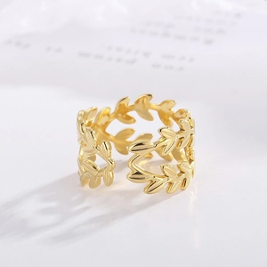 Detailed close-up of adjustable golden leaf ring with intricate olive branch textures