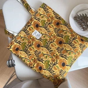 Close-up of yellow floral cotton tote bag with vintage Indian block print and textile label