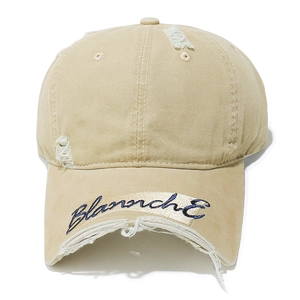 Detail of distressed khaki cotton baseball cap with Blanche embroidery and frayed holes