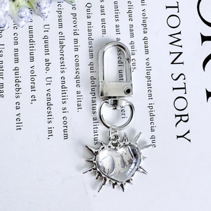 Polished silver heart pendant keychain with starburst design and lobster clasp detail