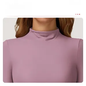 Detail view of the high neck design and elastic texture of the purple yoga top