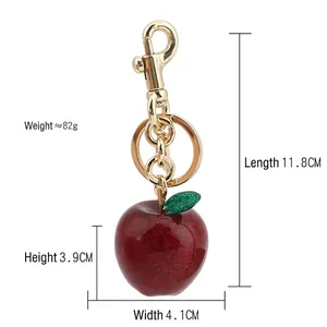 Red glitter apple keychain with gold carabiner and green leaf charm, 11.8cm long